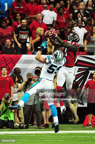 Julio Jones of the Atlanta Falcons makes a catch for a touchdown over Luke Kuechly of the Carolina Panthers during the second half at the Georgia...