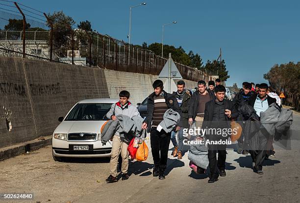 Refugees walk to Moria's camp after refugees arrived in the south-east of the Lesbos Island, Greece on December 27, 2015.
