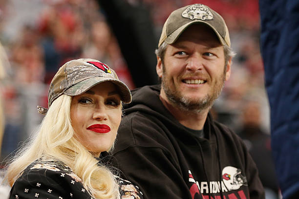 Musicians Gwen Stefani and Blake Shelton attend the NFL game between the Green Bay Packers and Arizona Cardinals at the University of Phoenix Stadium...
