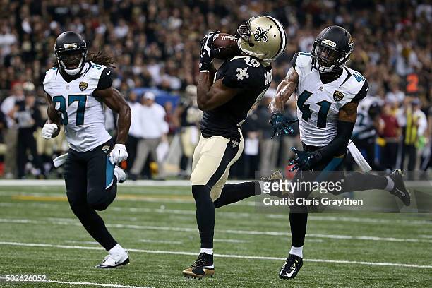 Brandin Cooks of the New Orleans Saints catches a pass for a touchdown in front of Nick Marshall and Johnathan Cyprien of the Jacksonville Jaguars...