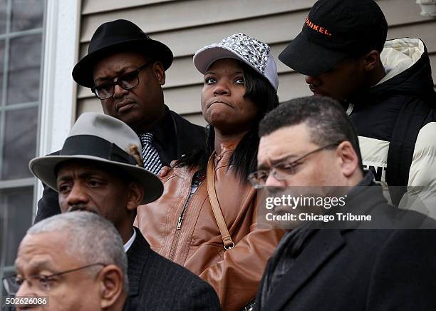 LaTarsha Jones, center, daughter of Bettie Jones, is surrounded by friends and family in front of Jones' home on Sunday, Dec. 27, 2015. Attorneys...