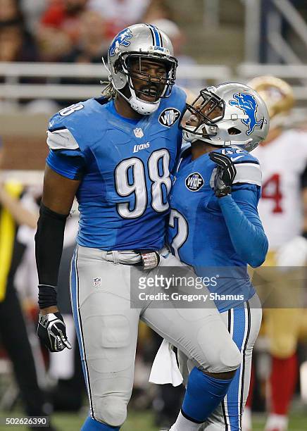 Devin Taylor and Isa Abdul-Quddus of the Detroit Lions celebrate a tackle for a lose while playing the San Francisco 49ers at Ford Field on December...