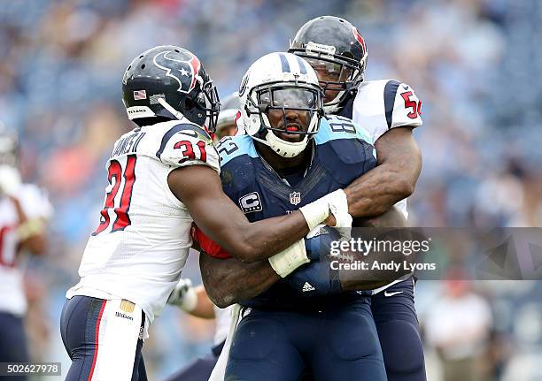 Charles James and Akeem Dent of the Houston Texans wrap up Delanie Walker of the Tennessee Titans at LP Field on December 27, 2015 in Nashville,...