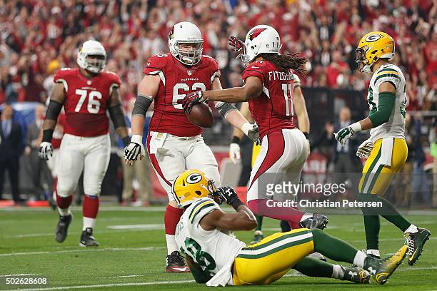 Wide receiver Larry Fitzgerald of the Arizona Cardinals celebrates with center Lyle Sendlein after scoring a 3 yard touchdown during the second...