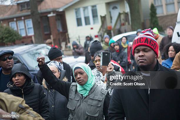 Family, friends and supporters gather outside the home of Bettie Jones and Quintonio LeGrier during a vigil on December 27, 2015 in Chicago,...