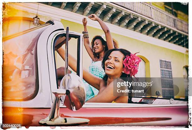 two young caribbean woman traveling in cuba - cuba car stock pictures, royalty-free photos & images