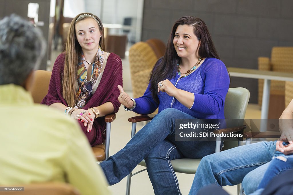 Woman discussing something with diverse group of people