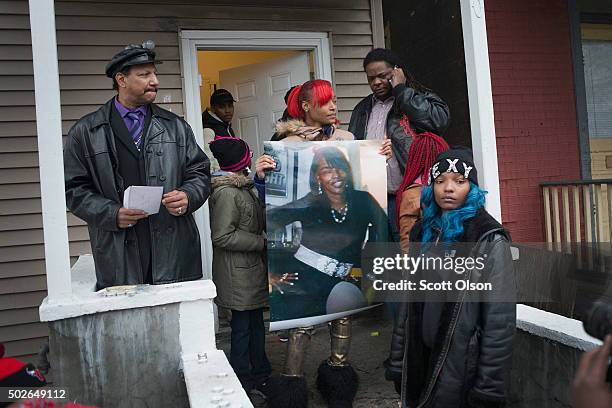 LaTonya Jones, the daughter of Bettie Jones, holds a picture of her mother during a vigil outside her home on December 27, 2015 in Chicago, Illinois....