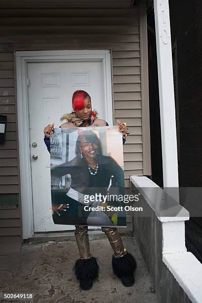 LaTonya Jones, the daughter of Bettie Jones, holds a picture of her mother during a vigil outside her home on December 27, 2015 in Chicago, Illinois....