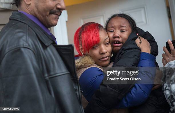 LaTonya Jones , the daughter of Bettie Jones, hugs a crying child during a vigil outside her home on December 27, 2015 in Chicago, Illinois. Bettie...