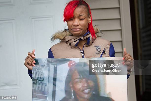 LaTonya Jones, the daughter of Bettie Jones holds a picture of her mother during a vigil outside her home on December 27, 2015 in Chicago, Illinois....