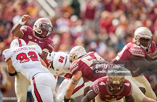 Riley Nicholson of the North Carolina State Wolfpack makes a late sack attaemt on Everett Golson during the game at Doak Campbell Stadium on November...
