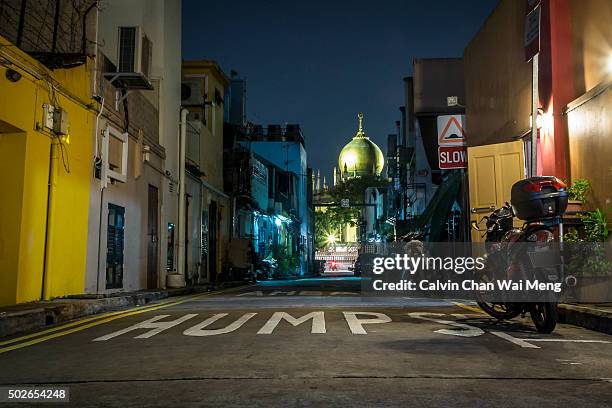 a night scene of singapore masjid sultan mosque in arab street - singapore alley stock pictures, royalty-free photos & images