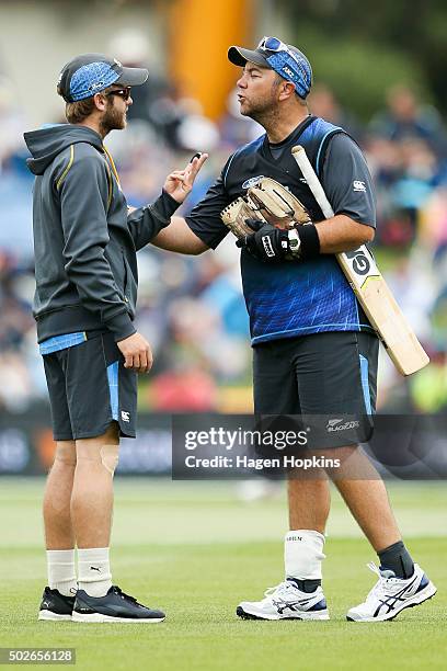 Kane Williamson of New Zealand speaks to batting coach Craig McMillan of New Zealand during the second One Day International game between New Zealand...