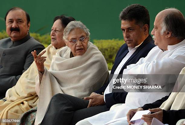 Former Delhi Chief Minister Sheila Dixit gestures as she speaks with congress leader Manish Tiwari and others during the party's foundation day...