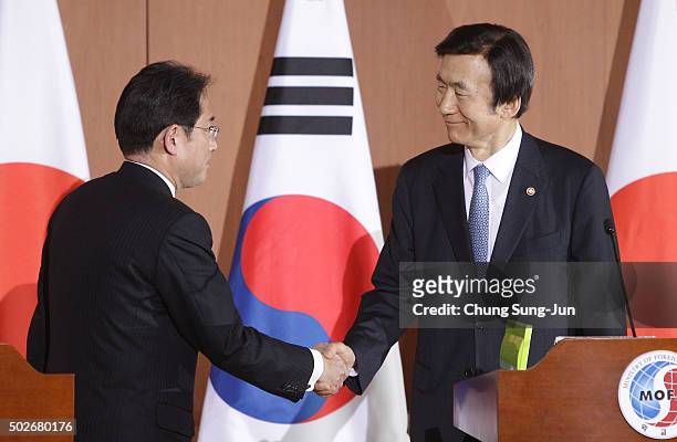 South Korean Foreign Minister Yun Byung-Se shakes hands with Japanese Foreign Minister Fumio Kishida after joint press conference at foreign ministry...