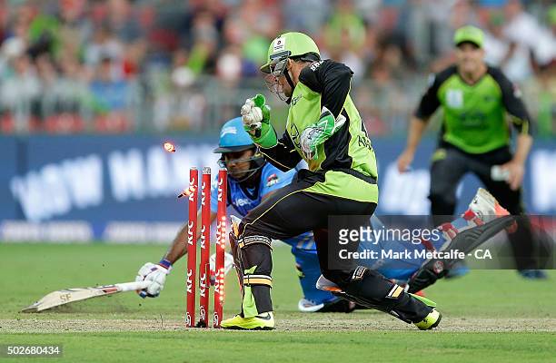 Chris Hartley of the Thunder knocks off the bails to dismiss Mahela Jayawardena of the Strikers by runout during the Big Bash League match between...