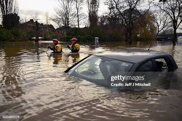 Rescue teams wade through flood waters that have inundated homes in the Huntington Road area of York after the River Foss burst its banks, on...