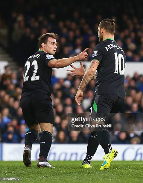 Xherdan Shaqiri of Stoke City celebrates scoring his team's first goal with his team mate Marko Arnautovic during the Barclays Premier League match...