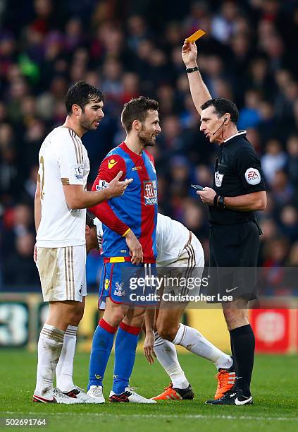 Yohan Cabaye of Crystal Palace is shown a yellow card by referee Neil Swarbrick during the Barclays Premier League match between Crystal Palace and...