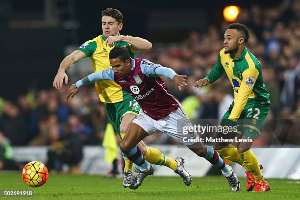 Scott Sinclair of Aston Villa competes for the ball against Robbie Brady and Nathan Redmond of Norwich City during the Barclays Premier League match...