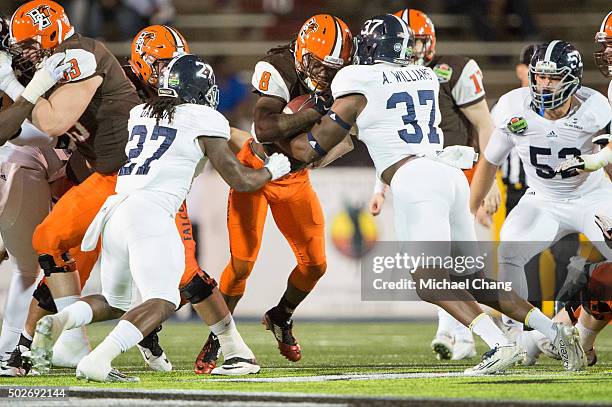 Linebacker Ironhead Gallon and linebacker Antwione Williams of the Georgia Southern Eagles tackle running back Travis Greene of the Bowling Green...