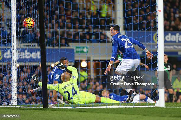 Joselu of Stoke City scores his team's third goal past Tim Howard of Everton during the Barclays Premier League match between Everton and Stoke City...