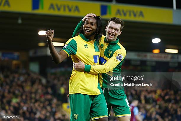 Dieumerci Mbokani of Norwich City celebrates scores his team's second goal with his team mate Jonathan Howson during the Barclays Premier League...