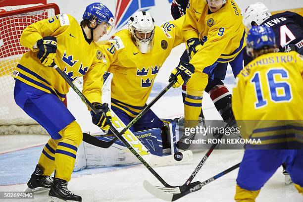 Sweden's Adam Ollas Mattsson, goalie Linus Söderström, Gabriel Carlsson and Carl Grundström defend the net against US Auston Matthews during the 2016...