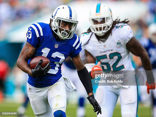 Hilton of the Indianapolis Colts is chased by Kelvin Sheppard of the Miami Dolphins during the second quarter of the game at Sun Life Stadium on...