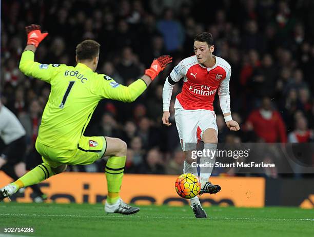 Mesut Ozil shoots past Bournemouth goalkeeper Artur Bouruc to score the 2nd Arsenal goal during the Barclays Premier League match between Arsenal and...