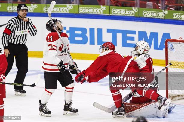 Canada's Rourke Chartier and Denmark's Morten Jensen fight for the puck at the goal of Denmark's goalie Mathias Seldrup during the 2016 IIHF World...
