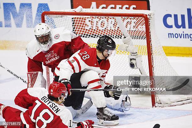 Canada's Lawson Crouse , Denmark's goalie Mathias Seldrup and Denmark's William Boysen vie for the puck during the 2016 IIHF World Junior Ice Hockey...