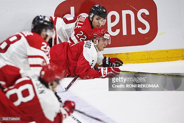 Canada's John Quenneville and Denmark's Anders Krogsgaard vie for the puck during the 2016 IIHF World Junior Ice Hockey Championship match between...