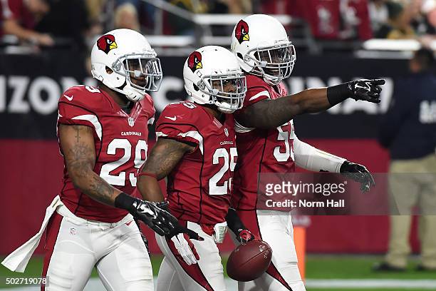 Jerraud Powers of the Arizona Cardinals and teammates Chris Clemons and Sean Weatherspoon celebrate a defensive touchdown against the Green Bay...