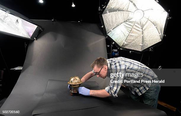 David Neikirk, digital imaging coordinator, sets up a 1607 William Blaeu celestial globe to be photographed at The Osher Map Library at the...
