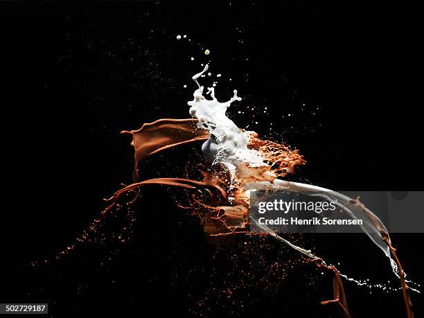 coloured liquid splash - coffee milk stockfoto's en -beelden