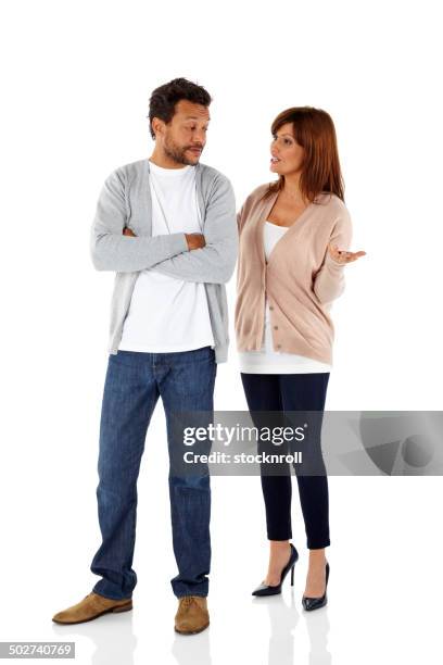 mature interracial couple having an argument - man standing talking stockfoto's en -beelden