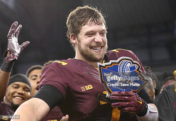 Quarterback Mitch Leidner of the Minnesota Golden Gophers celebrates a bowl win and the Most Valuable Player of the Game over Central Michigan...