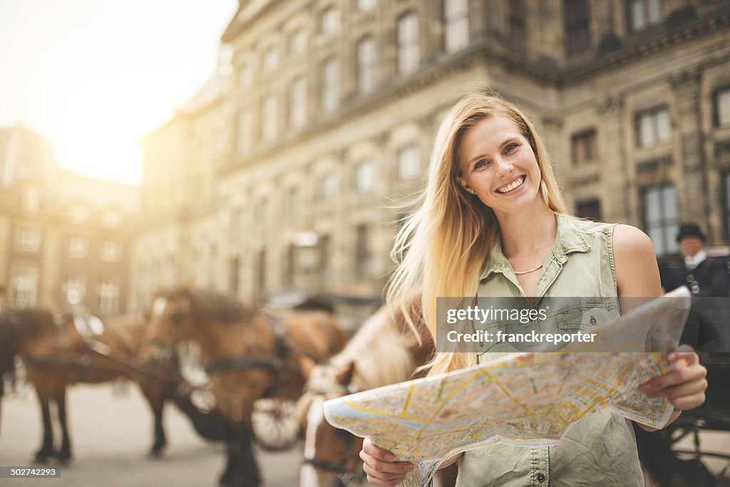 Tourist in amsterdam looking map of the city