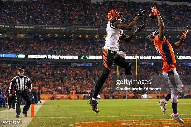 Wide receiver A.J. Green of the Cincinnati Bengals makes a 5-yard touchdown reception under coverage by cornerback Aqib Talib of the Denver Broncos...