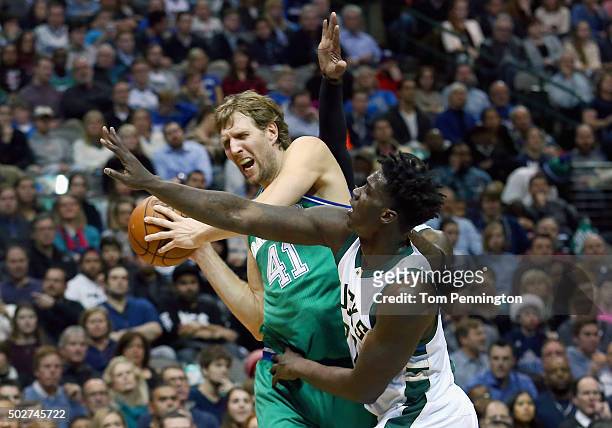 Dirk Nowitzki of the Dallas Mavericks controls the ball against Johnny O'Bryant III of the Milwaukee Bucks in the first half at American Airlines...
