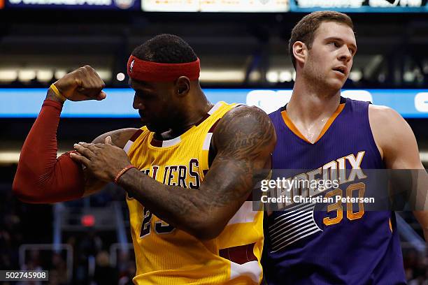 LeBron James of the Cleveland Cavaliers flexes after scoring and drawing a foul past Jon Leuer of the Phoenix Suns during the first half of the NBA...