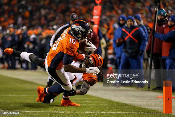 Wide receiver Emmanuel Sanders of the Denver Broncos makes a reception for an 8-yard touchdown under coverage by cornerback Adam Jones of the...