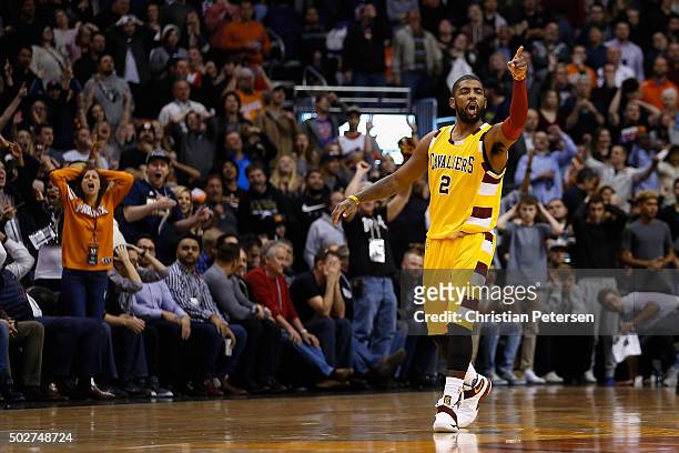 Kyrie Irving of the Cleveland Cavaliers points to the bench after hitting a three point shot against the Phoenix Suns during the final moments of the...