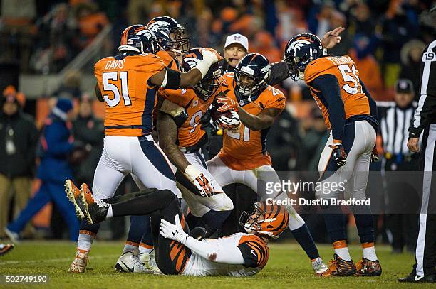 Outside linebacker DeMarcus Ware of the Denver Broncos comes up with the football after recovering a fumble by quarterback AJ McCarron of the...