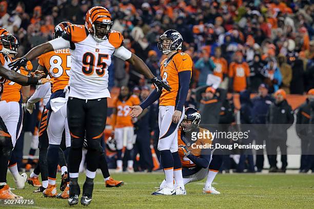 Defensive end Wallace Gilberry of the Cincinnati Bengals, kicker Brandon McManus and punter Britton Colquitt of the Denver Broncos react after...