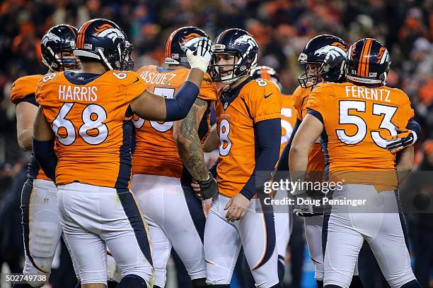 Denver Broncos players, including tackle Ryan Harris, celebrate with kicker Brandon McManus after McManus kicked a go-ahead 37 yard field goal in the...