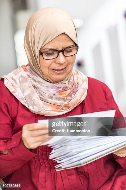middle eastern woman cheking the mail - chubby arab stock pictures, royalty-free photos & images