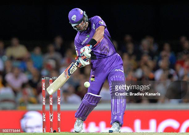 Dan Christian of the Hurricanes hits the ball out of the Gabba Stadium for a six during the Big Bash League match between the Brisbane Heat and...